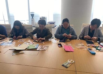 Our team in Beijing decorating cards to uplift the children of migrant workers.