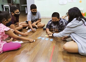 Playing card games like Wanted help the children build social and decision-making skills.
